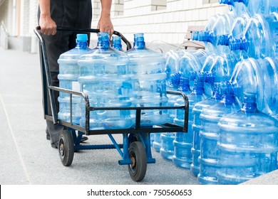 Senior man Happy Delivery Man Holding Trolley With Water Bottles