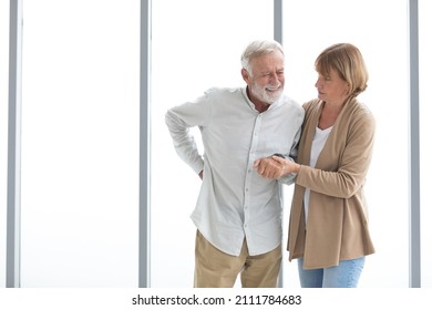 senior man have a back pain, senior woman helping and support him - Powered by Shutterstock