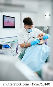 Senior Man Having Dental Drill Procedure During Medical Appointment With Dentist At Dental Clinic. 