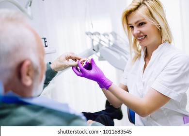 Senior Man Having Dental Treatment At Dentist's Office. 