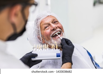 Senior Man Having Dental Treatment At Dentist's Office. 