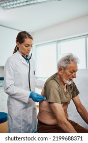 Senior Man Having Medical Exam By Cardiologist At Doctor's Office.