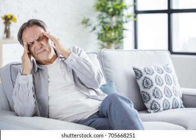 Senior man with headache - Powered by Shutterstock