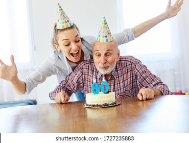 Senior man and his daughter celebrating his 80th birthday at home - Powered by Shutterstock