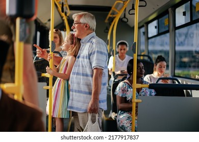 A senior man and his granddaughter are having a ride in the public transport - Powered by Shutterstock