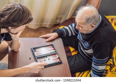 Senior man and his grandson play backgammon - Powered by Shutterstock