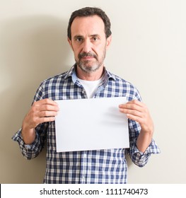 Senior Man Holding Blank Paper Sheet With A Confident Expression On Smart Face Thinking Serious