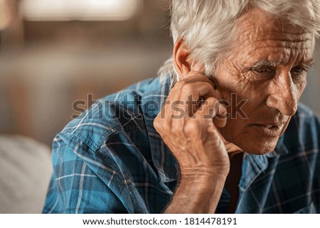 Similar – Image, Stock Photo Hand holding an acoustic guitar with black background with a dramatic and cinematic tone in chiaroscuro