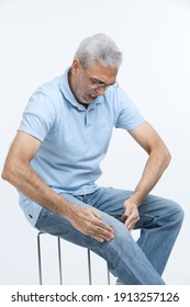 Senior man holding his painful knee 