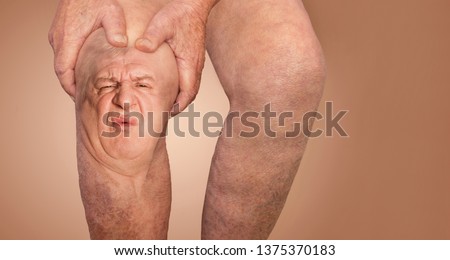 Senior man holding the knee with pain. Collage. Concept of abstract pain and despair. The elderly pensioner and problems. Old age and illnesses. 86-year-old Caucasian model. healthcare concepts