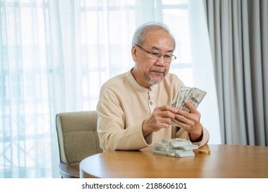 Senior Man Holding Money In Both Hands,Happy Senior Man Celebrating Financial Success.