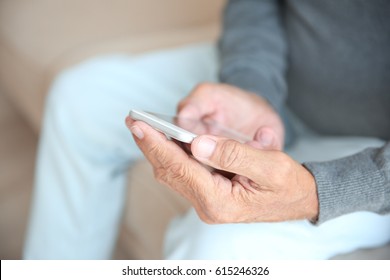 Senior Man Holding Smart Phone, Closeup