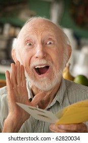 Senior Man At Home Reading Greeting Card