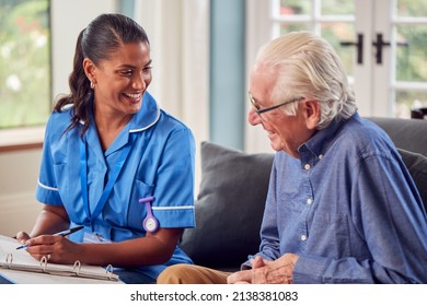 Senior Man At Home Talking To Female Nurse Or Care Worker In Uniform Making Notes In Folder - Powered by Shutterstock