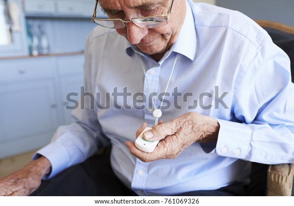 Senior Man\
At Home Using Distress Alarm Call\
Button