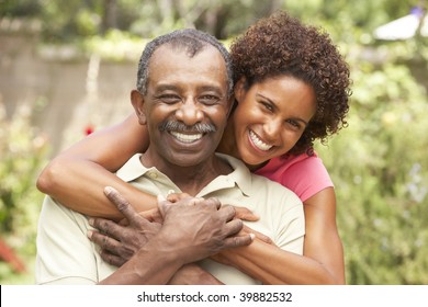 Senior Man Hugging Adult Daughter