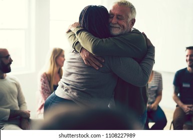 Senior Man Hugging Woman In A Support Group