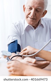 Senior Man With Hypertension Having Regular Blood Pressure Control