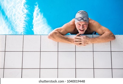 Senior Man In An Indoor Swimming Pool.