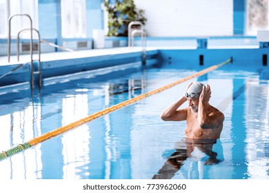 Senior Man In An Indoor Swimming Pool.