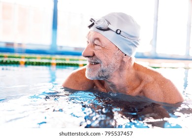 Senior Man In An Indoor Swimming Pool.