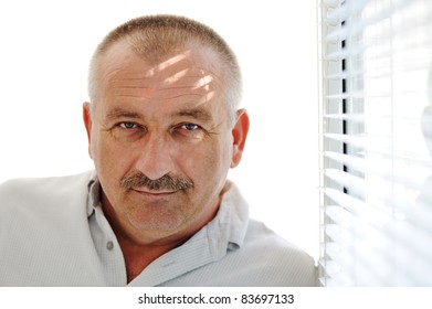 Senior man indoor, windows sunlight - Powered by Shutterstock