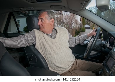 Senior Man Inside The Car Driving Backwards