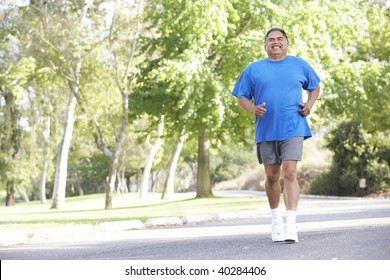 Senior Man Jogging In Park