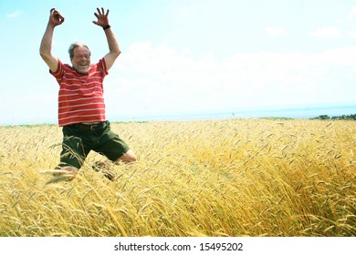 Senior Man Jumping In A Field