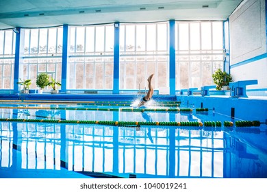 Senior Man Jumping In The Swimming Pool.