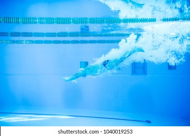 Senior Man Jumping In The Swimming Pool.