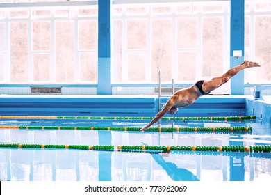 Senior man jumping in the swimming pool.