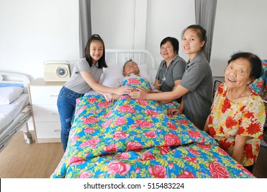 A Senior Man Laying On A Hospital Bed And Answering To His Doctor's Questions, Family Member Visit Around Bed, Asian Family Worry. 80s Man