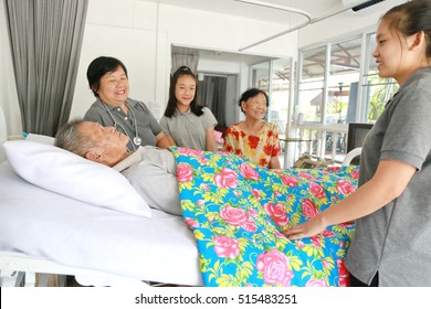 A Senior Man Laying On A Hospital Bed And Answering To His Doctor's Questions, Family Member Visit Around Bed, Asian Family Worry. 80s Man