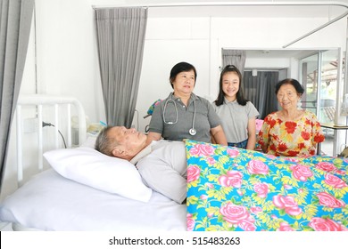 A Senior Man Laying On A Hospital Bed And Answering To His Doctor's Questions, Family Member Visit Around Bed, Asian Family Worry. 80s Man