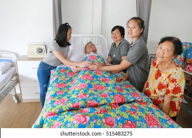 A Senior Man Laying On A Hospital Bed And Answering To His Doctor's Questions, Family Member Visit Around Bed, Asian Family Worry. 80s Man