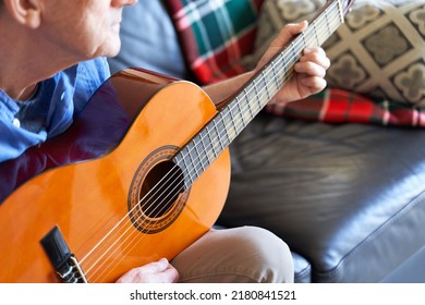 Senior Man Learning To Play Guitar