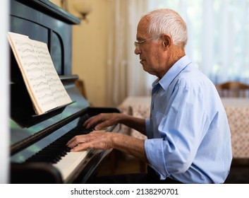 Senior Man Learning To Play Piano