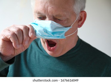 Senior Man Lifts His Medical Mask To Gasp For Air