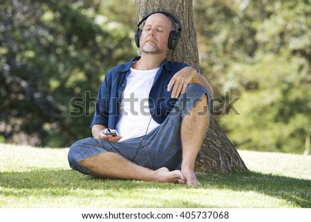 A senior man listening to music
