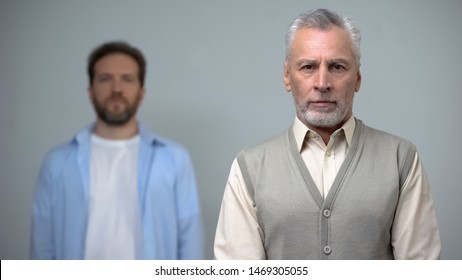 Senior Man Looking At Camera, Middle-aged Male Standing Behind, Pension Reform