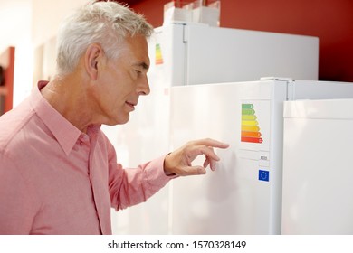 A senior man looking at fridge freezers in an electrical shop - Powered by Shutterstock