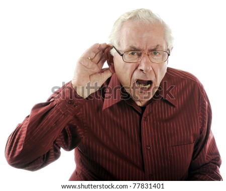A senior man looking grumpy as he calls out and strains to here.