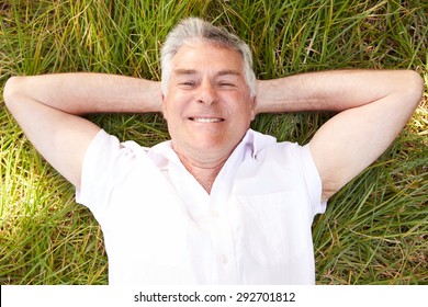 Senior man lying on grass relaxing - Powered by Shutterstock