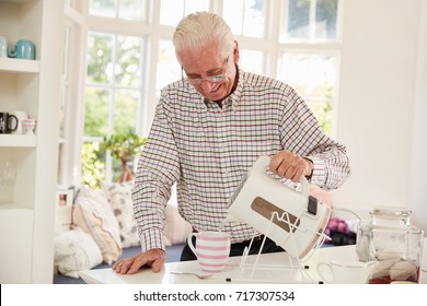 Senior Man Making Cup Of Tea At Home