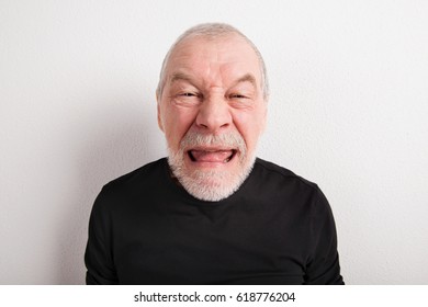 Senior Man Making Funny Face, Studio Shot.