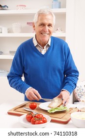 Senior Man Making Sandwich In Kitchen