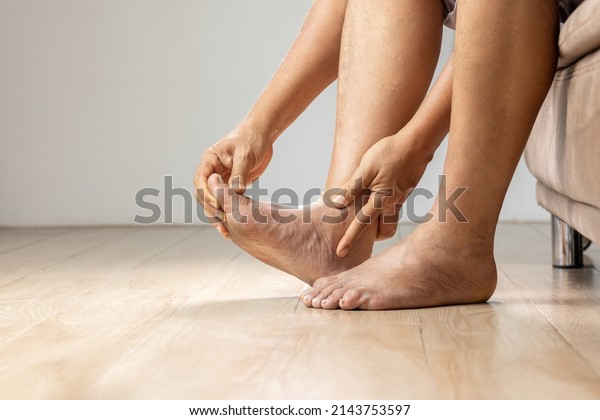 Senior Man massage foot with painful swollen\
gout inflammation