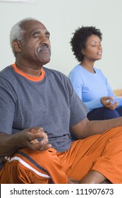 Senior Man Meditating In Lotus Position