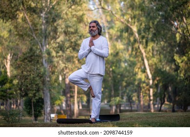 Senior man meditating in nature, doing Indian classic Yoga  - Powered by Shutterstock